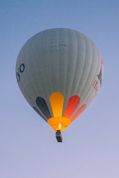 A Hot Air Balloon Flying Under a Blue Sky