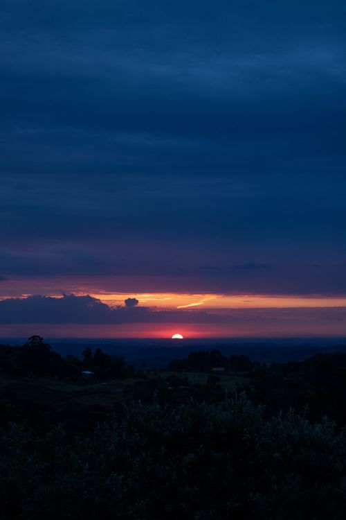 Free Captivating sunset with a glowing sky over a peaceful rural landscape. Stock Photo