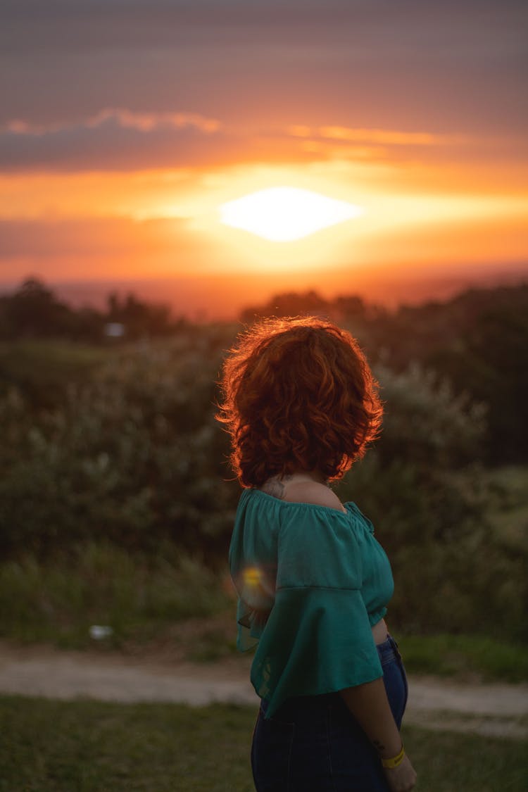 A Woman Wearing An Off Shoulder Watching A Sunset