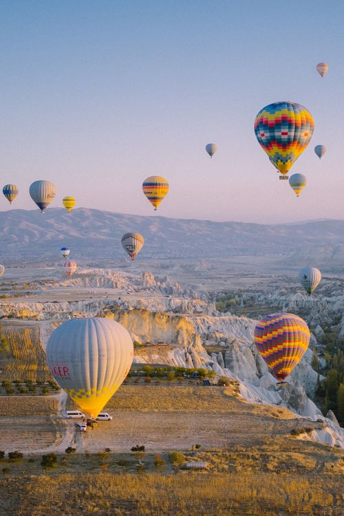 Free Scenic hot air balloons over Cappadocia's unique landscape at sunrise. Perfect for travel inspiration. Stock Photo