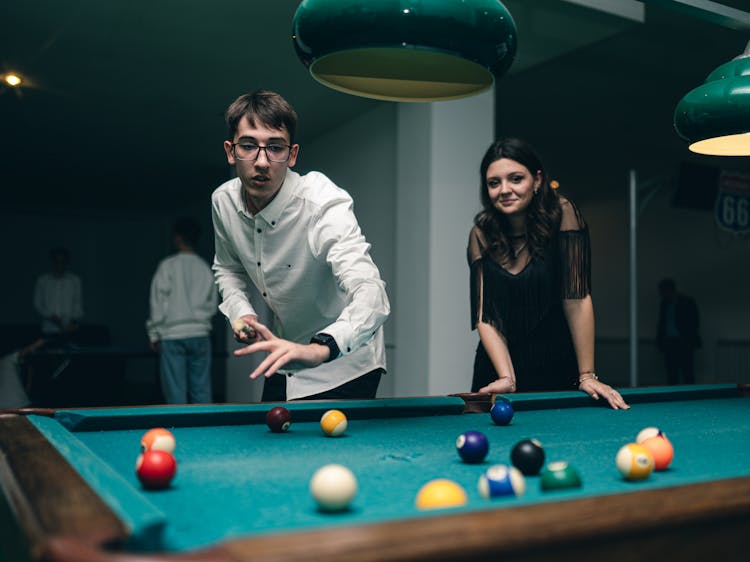 Woman And Man Playing Billiard