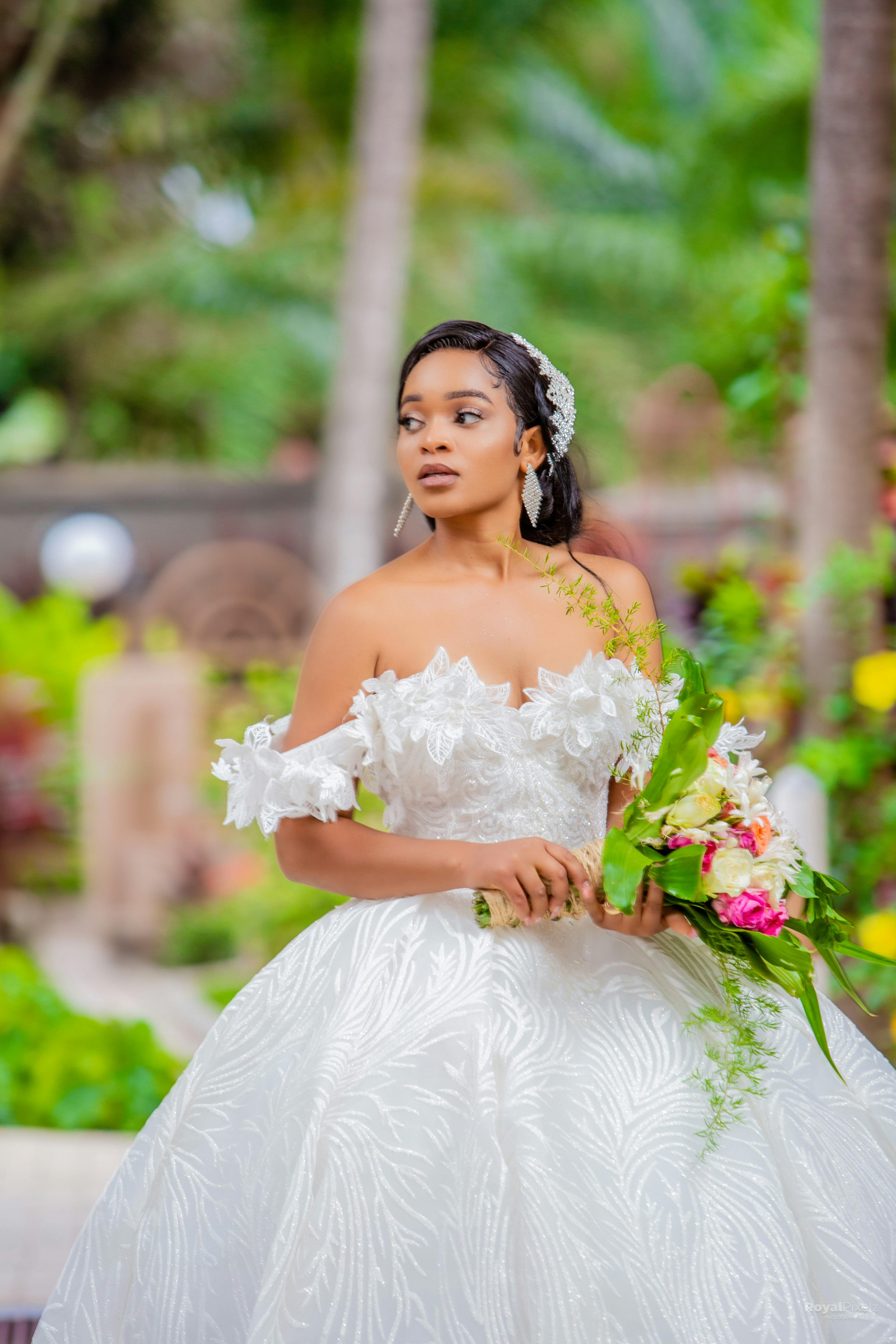 Woman In White Wedding Dress Holding Bouquet Of Flowers · Free Stock Photo