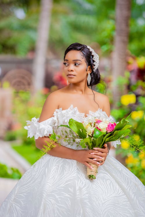 Bride Holding a Bouquet of Flowers Looking Sideways 
