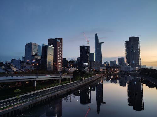 City Skyline Across Body of Water during Night Time