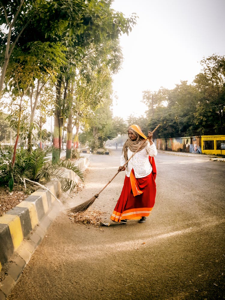 Woman Sweeping The Road 