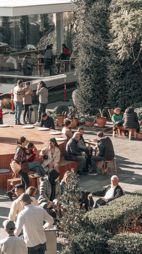 Free People enjoying outdoor leisure in a vibrant Istanbul square, capturing casual urban life. Stock Photo