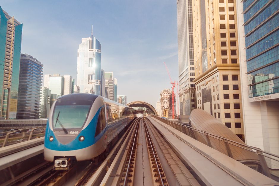Dubai Metro train arriving at a station, showing a Nol Card