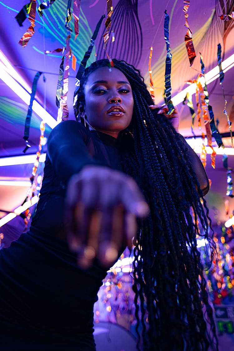 Woman At Party In Nightclub Pointing At Screen