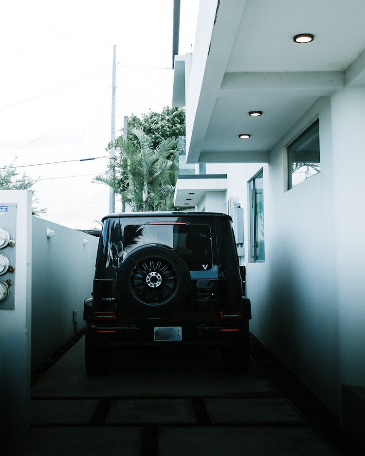 Rear Of A Black Car Parked In The Yard