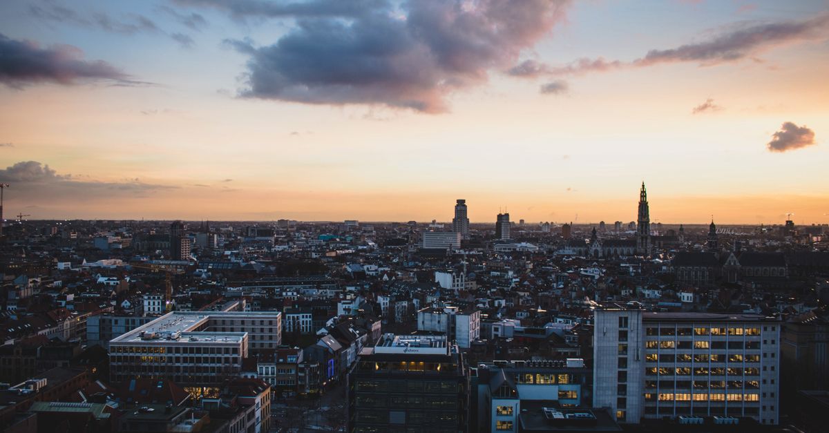 A stunning aerial view of Antwerp, Belgium, cityscape at dusk with vibrant sky colors.