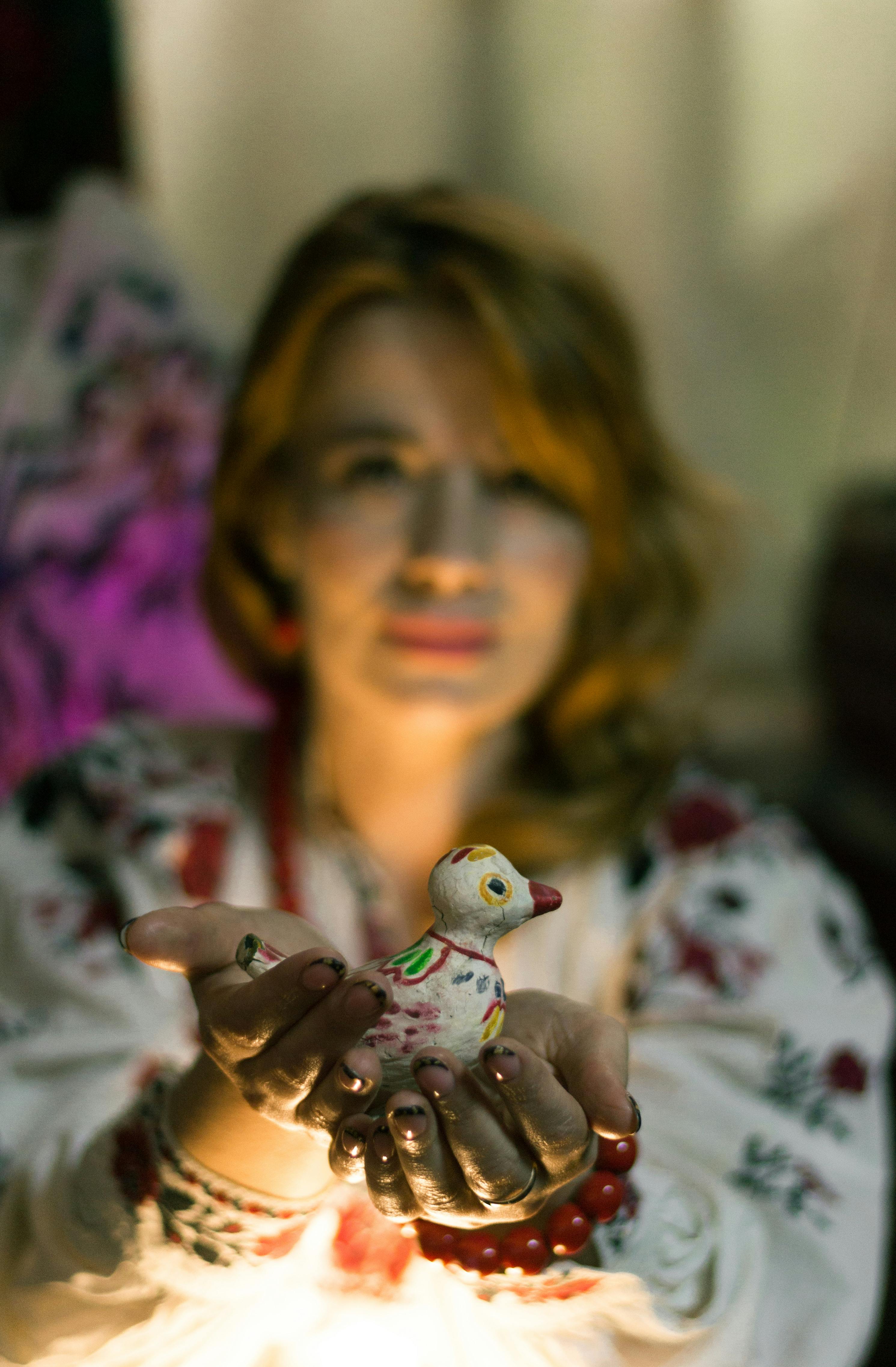 woman holding handmade duck figurine