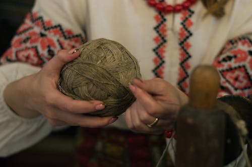 Person Holding Brown Yarn