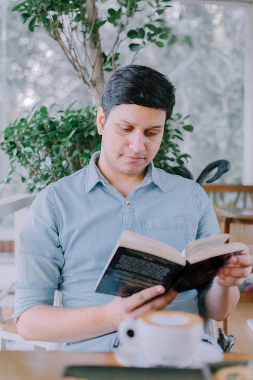 Photo of a Man Reading Book