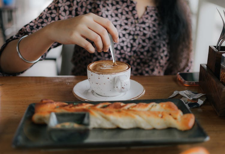 Woman Drinking Coffee In Cafe