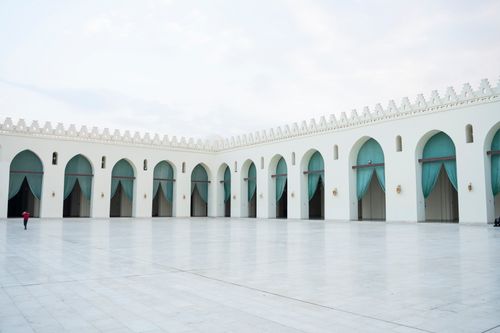 Free Beautiful open courtyard with arches and turquoise drapes, showcasing classic Ottoman architecture. Stock Photo