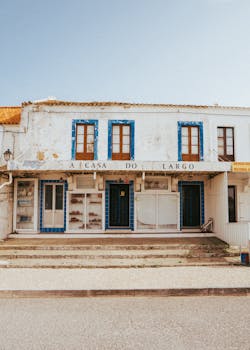A rustic and charming vintage house with blue accents in Nazaré, Portugal.