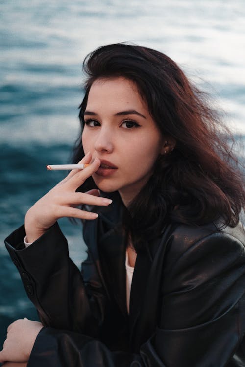 Young Woman Wearing Black Leather Jacket  Smoking Cigarette