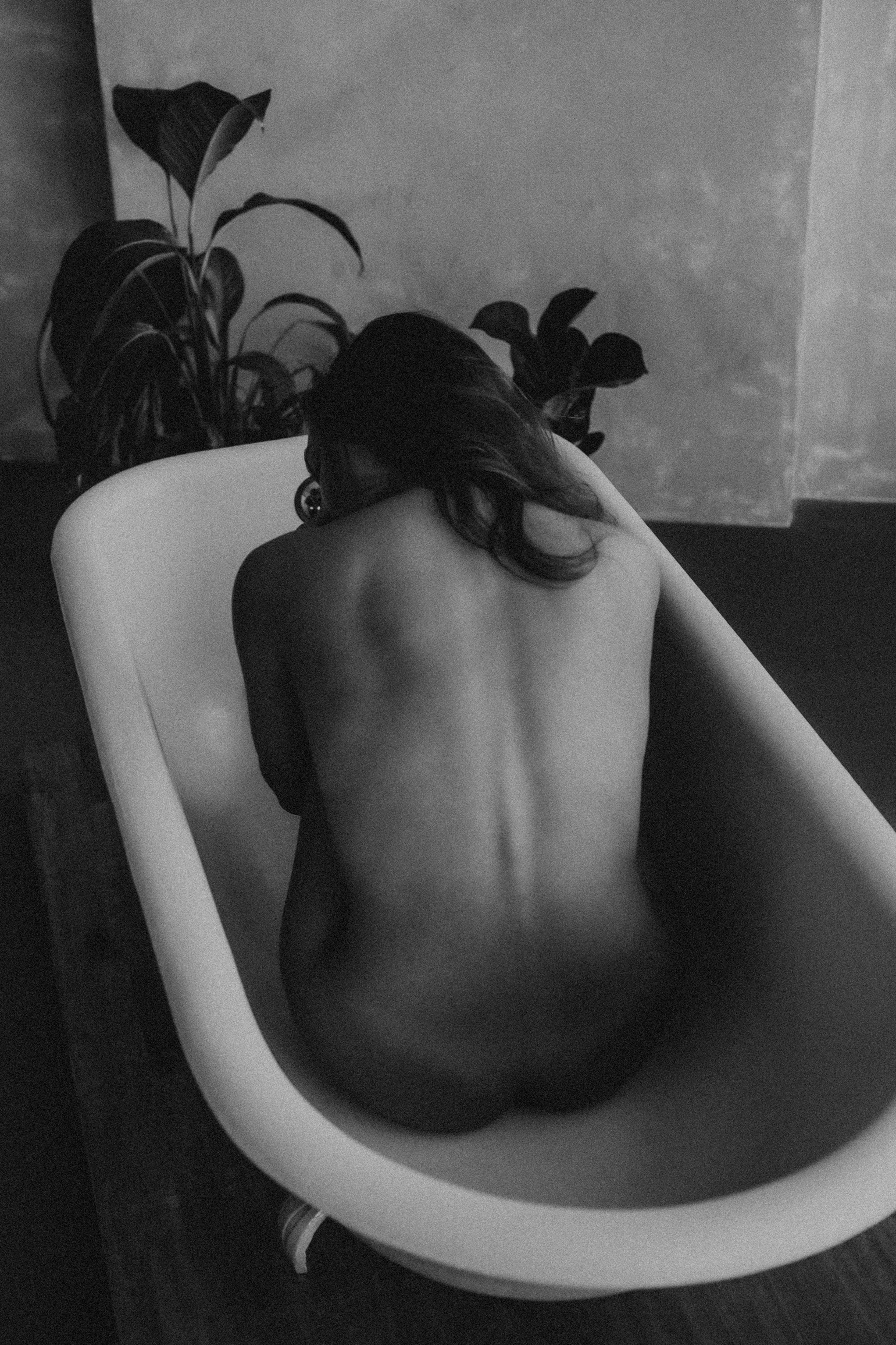 woman sitting in bathtub