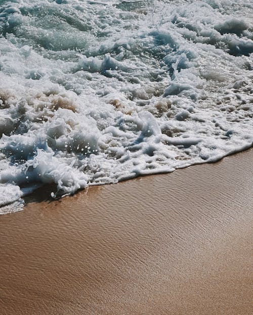 A Close-Up Shot of a Wave Crashing the Shore