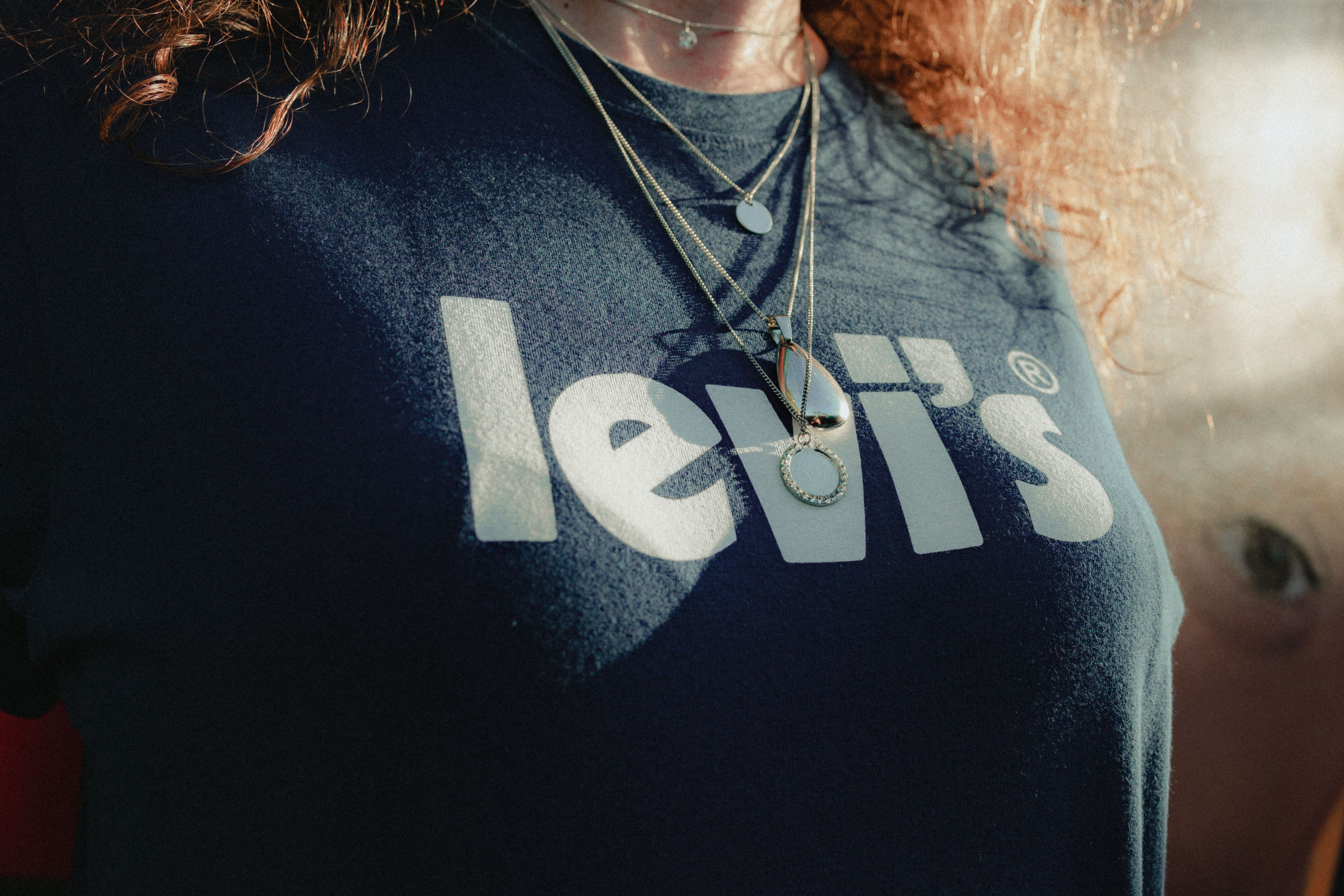 Woman in Black Crew Neck T-shirt Wearing Necklaces · Free Stock Photo