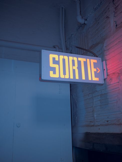 A glowing 'Sortie' sign indicating an exit in Montreal, Canada.