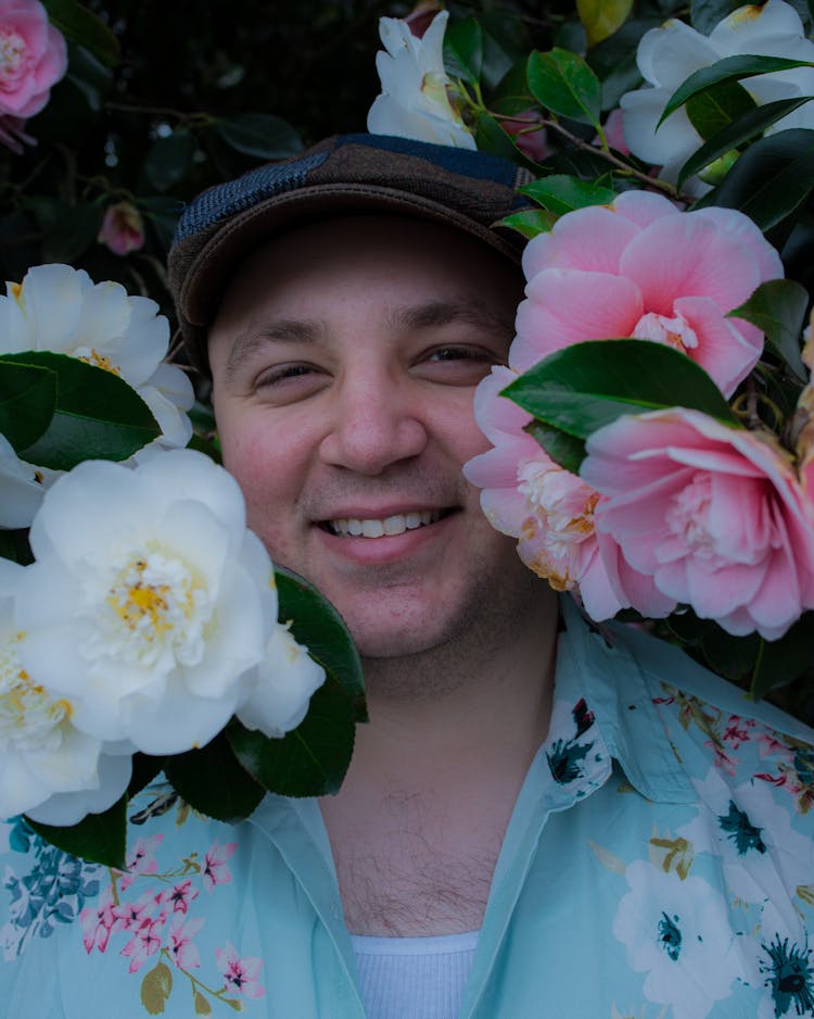 A Man Smiling With Flowers 