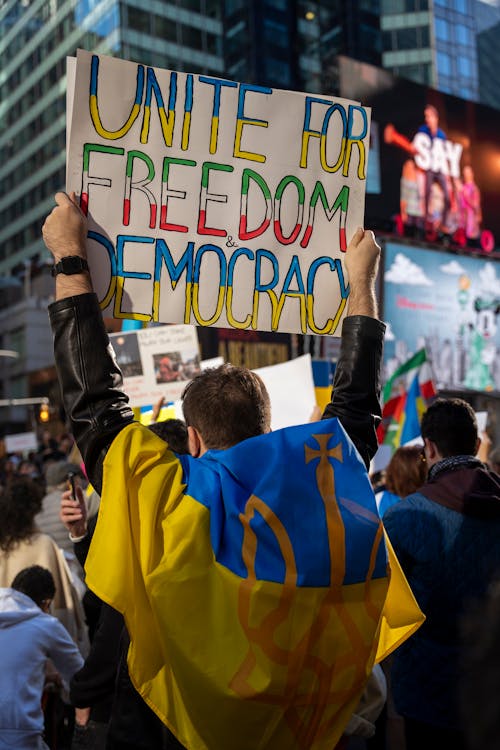 Man with Flag of Ukraine and Banner on Demonstration