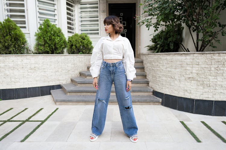 Woman In Jeans Posing On Street