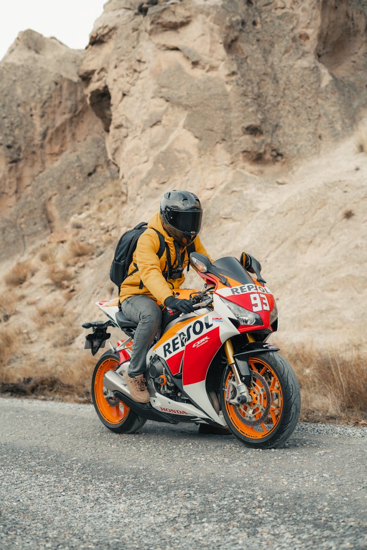 Man In Helmet Riding Motorbike In Desert