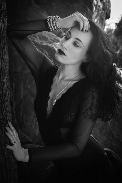 Grayscale Photo of Woman in Black Long Sleeve Dress