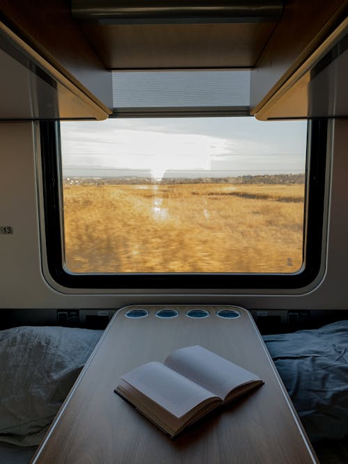 Free Countryside behind Train Window Stock Photo