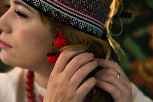 Close Up Photo of Woman with Knit Hat Fixing Her Hair