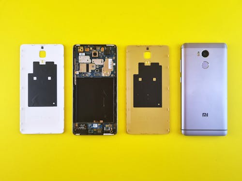 Dismantled Smartphone on Yellow Surface