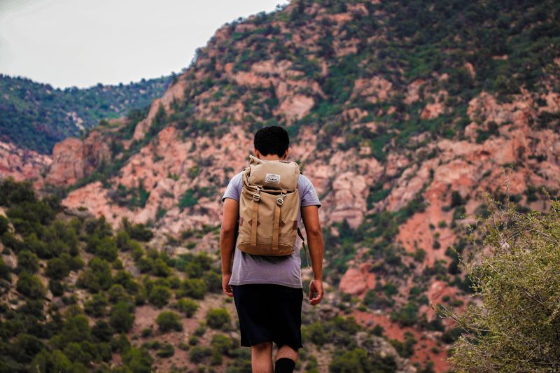 A lone backpacker hikes a stunning mountain trail, embracing nature and adventure