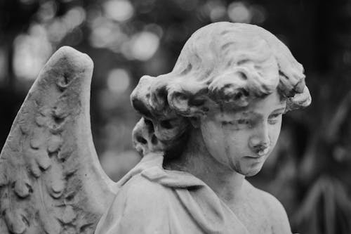 Close-up of an Angel Statue in Grayscale Photography 