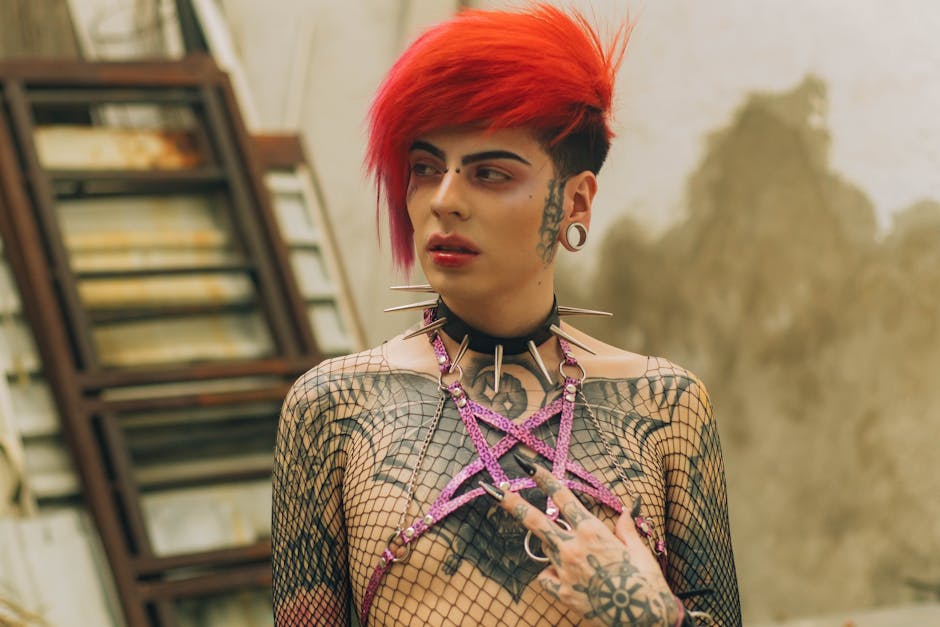 Fashion portrait photo of a Cross dressed guy, wearing drag makeup with red hair in a gothic glam rocker style wearing a pink animal print headgear forming a pentagram