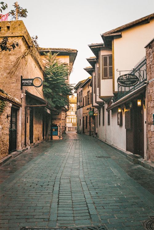 Free Discover a peaceful alley with charming historical architecture in a quaint town. Stock Photo