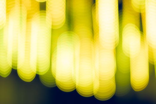 A vibrant abstract image showcasing yellow defocused light bokeh patterns.