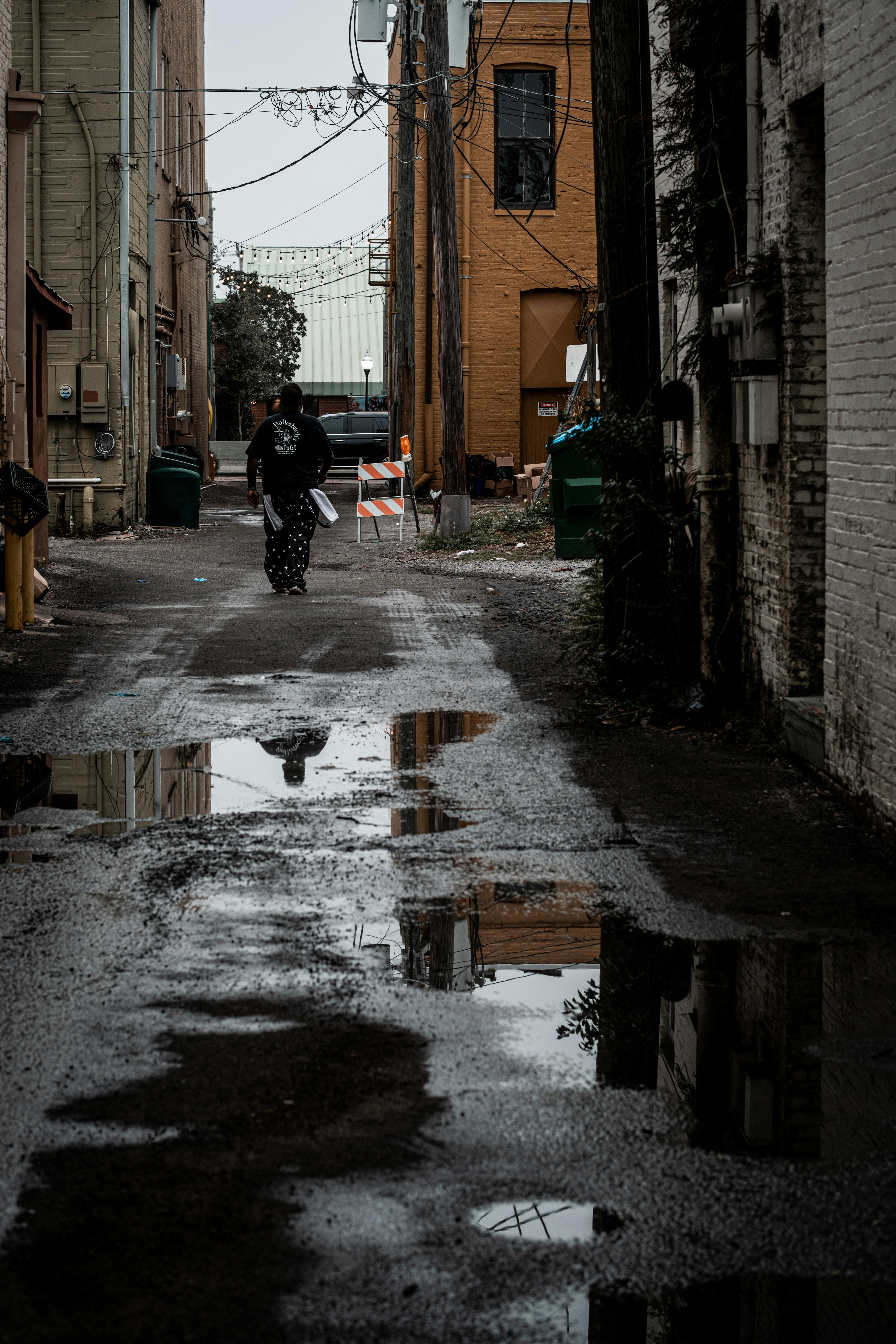 person in black jacket walking on street