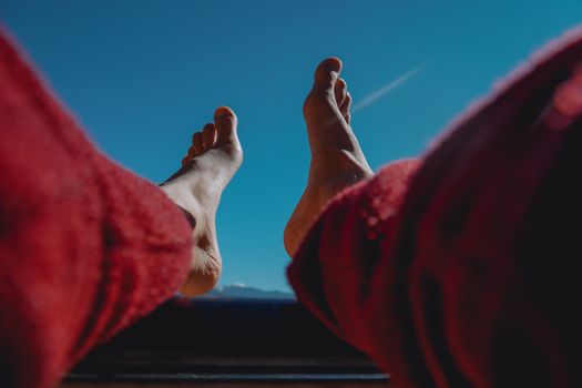 Feet in Red Pants against Blue Sky