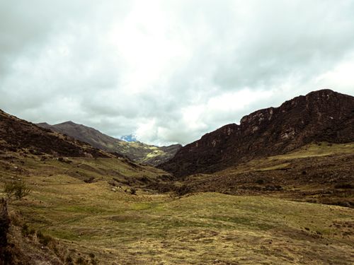 Free Explore the stunning, rugged terrain of Sumapaz, Colombia, with its mountainous landscape and dramatic sky. Stock Photo