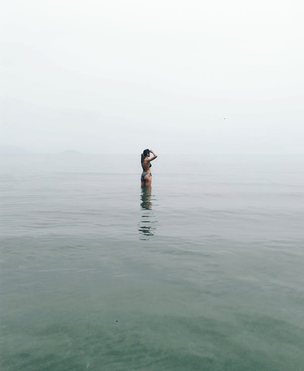 Woman Standing in Body of Water