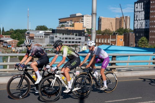 Photo of Men Cycling Together