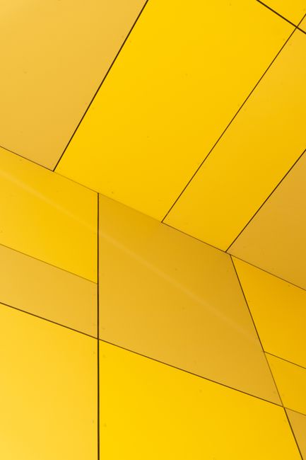 Abstract geometric arrangement of yellow panels in a modern architectural design, perfect for aesthetic concepts.