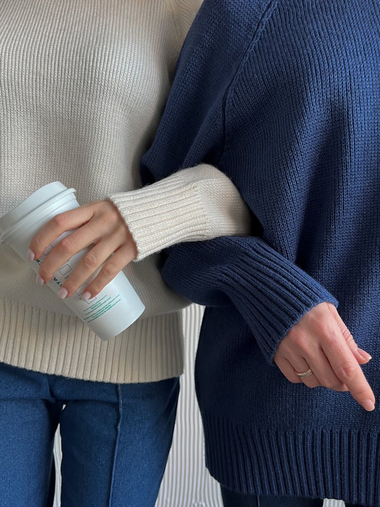 Close Up Of Woen Hands In Sweaters