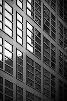 Geometric design of a modern skyscraper facade in Hamburg, Germany, captured in monochrome.
