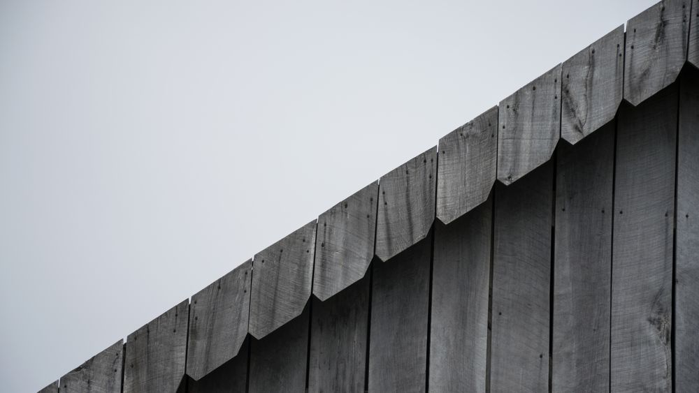 Close-up of a wooden building exterior showing clean siding texture and linear detail