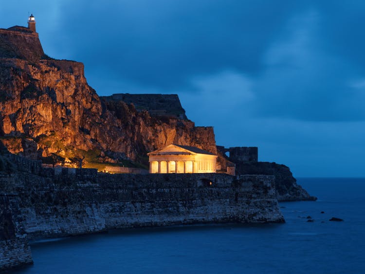 Building With Pillars On Cliff Coast