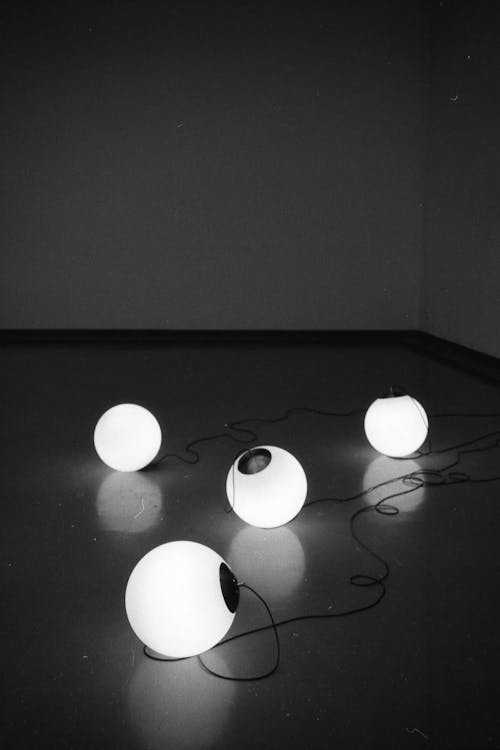 Black and White Pictures of Ball Shaped Lights on a String 