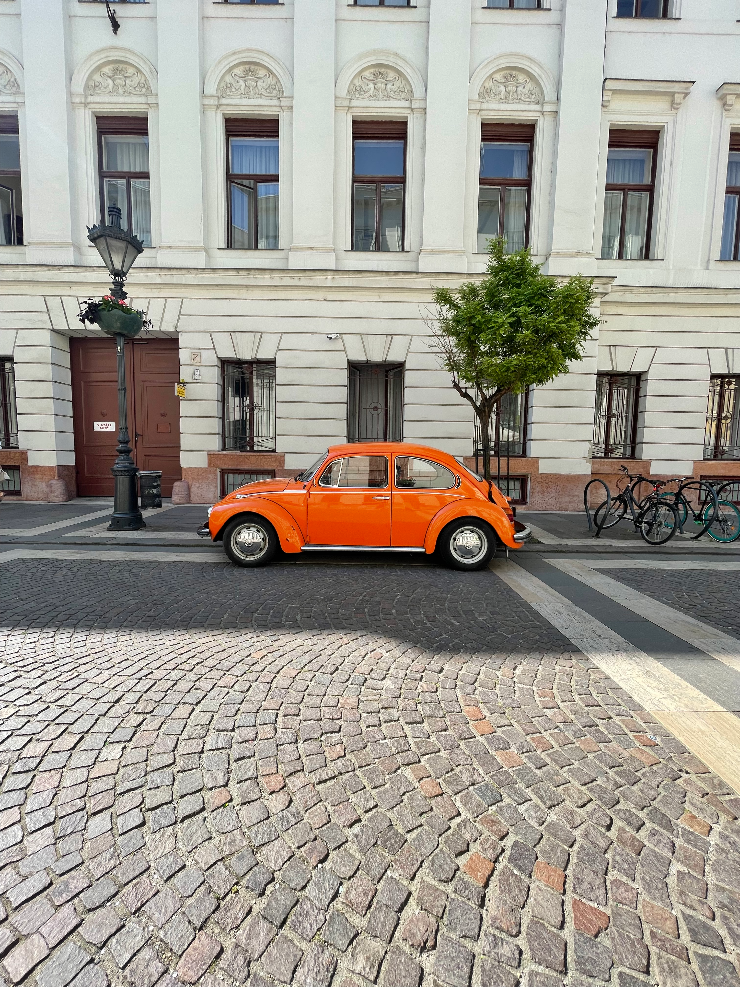 Vintage Orange Volkswagen Beetle Parked in front of a Building in City ...